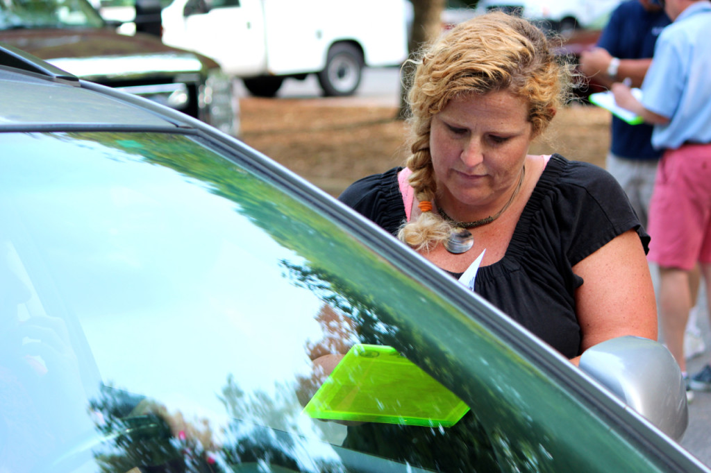 Revenue investigator Maggie Blynn helps a customer during a drive through personal property tax appeal. [John-Henry Doucette/The Princess Anne Independent News]
