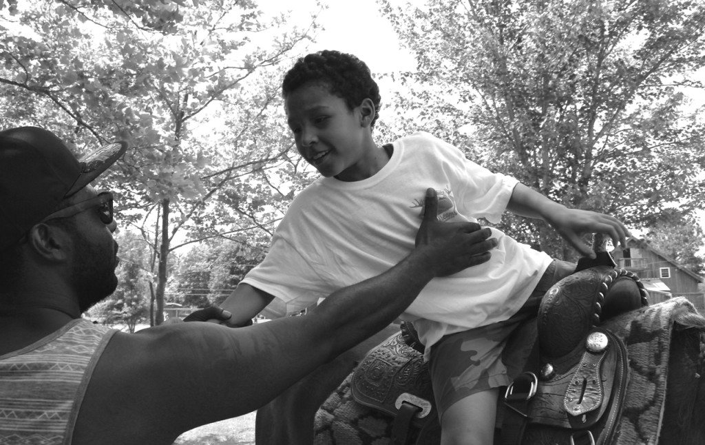 Jai’Shon Johnson, 9, dismounts after a ride with a help from his dad, Daniel Hockaday, 32. [John-Henry Doucette/The Princess Anne Independent News]