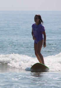 Alyssa Stanford surfing at Sandbridge. [John-Henry Doucette/The Princess Anne Independent News]