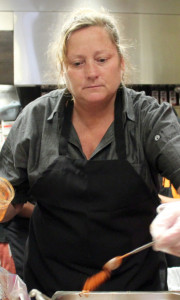 Michelle Holland, co-woner of Smoked From Above BBQ, spices and sauces pulled pork. [John-Henry Doucette/The Princess Anne Independent News]