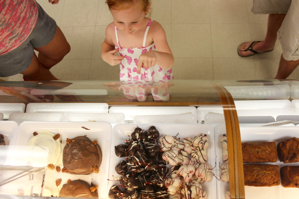 Taylor Holcomb, 4, points out chocolate covered cherries in a display at Seasons Best Bakery at the Virginia Beach Farmers Market on Tuesday, July 14, during a visit with her parents, April and Joshua Holcomb of Ocean Lakes.  [John-Henry Doucette/The Princess Anne Independent News]