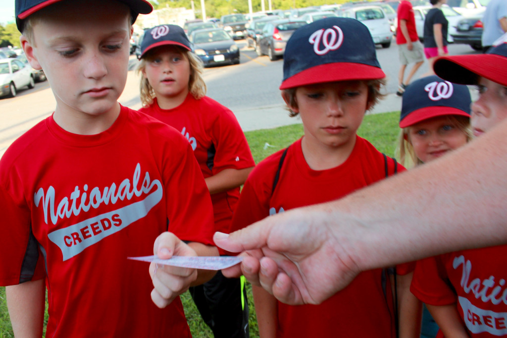  Silas Hoggard gets his ticket for the Norfolk Tides game at Harbor Park from one of the coaches. With him are Brady Saar, Dylan Joyner and Leah Gentry. [John-Henry Doucette/The Princess Anne Independent News]