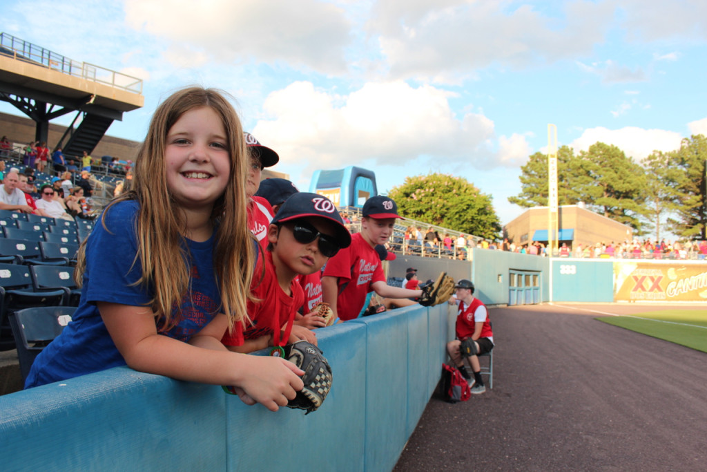 Torrence Spreder and Daniel Martin, wearing suglasses, are among those sitting along the field. [John-Henry Doucette/The Princess Anne Independent News]