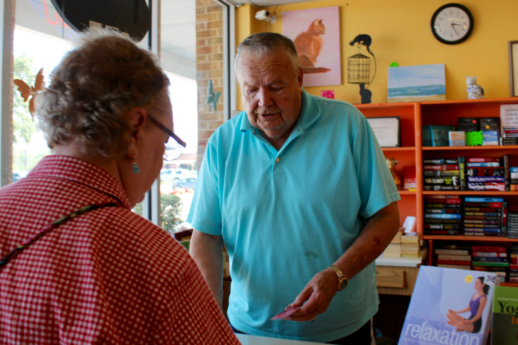 Bob Barnes assists a customer at the Strawbridge location of Barritt’s Books. [John-Henry Doucette/The Princess Anne Independent News]
