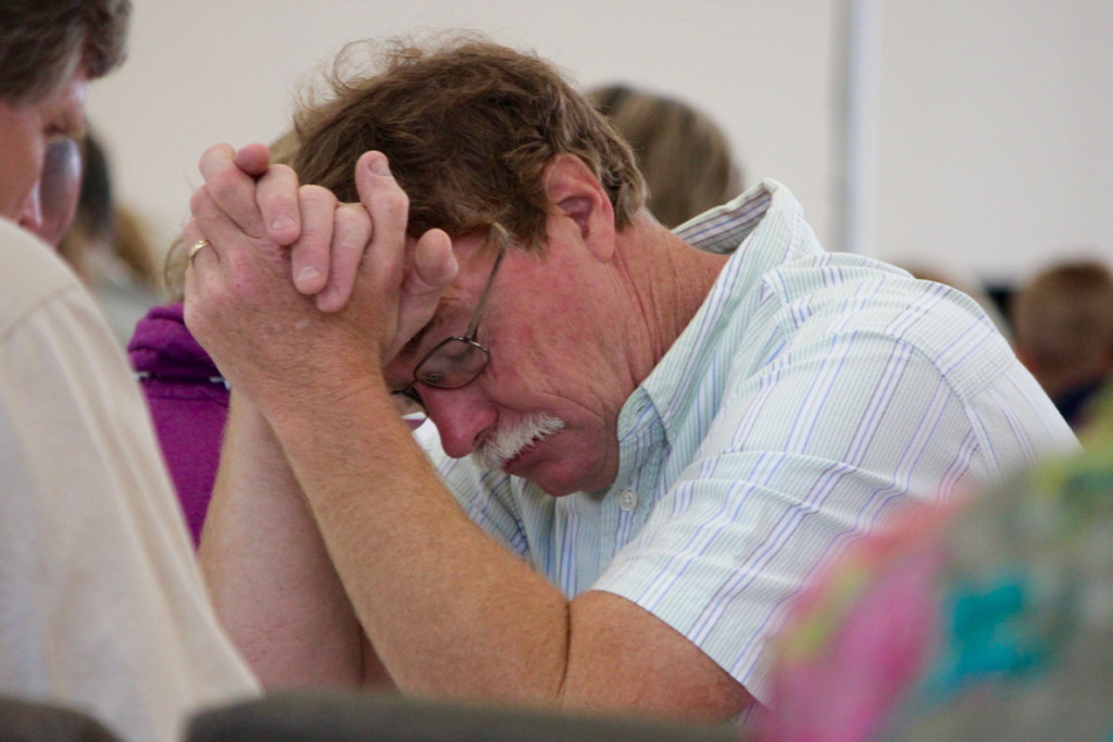 Glenn Taylor of Back Bay, a lifelong member of the church, is deep in prayer during the service. “I see the vision of it now,” he said later of the building’s potential. [John-Henry Doucette/The Princess Anne Independent News]