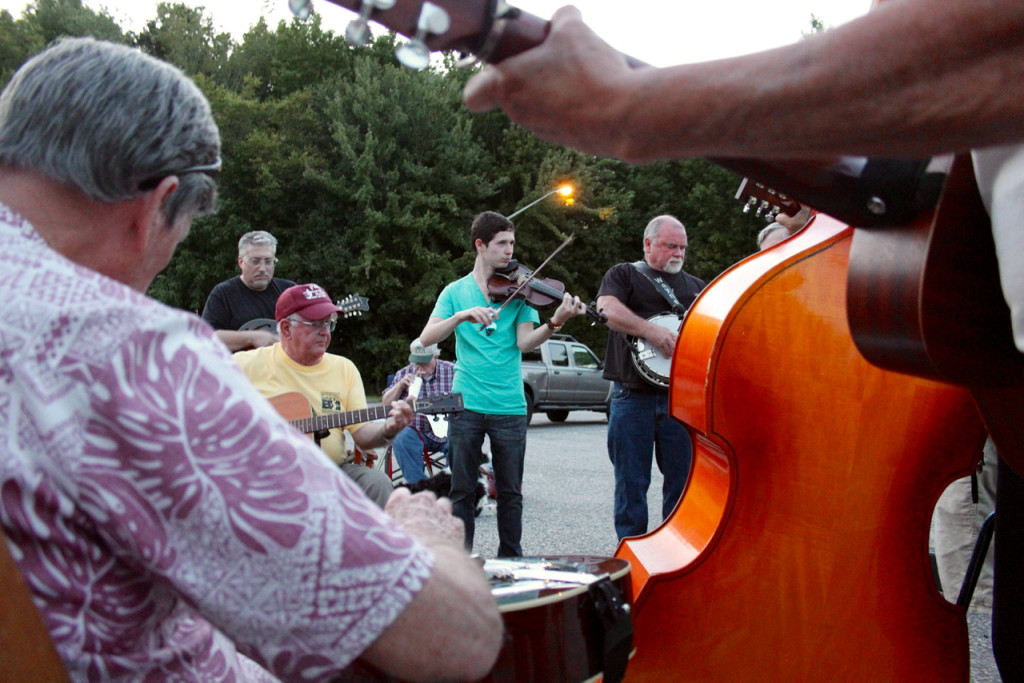 Fridays at the Virginia Beach Farmer’s Market bring music to the stage through a concert series. On same night, musicians from Hampton Roads, North Carolina and beyond gather in the parking lot for an enduring bluegrass jam. [John-Henry Doucette/The Princess Anne Independent News]