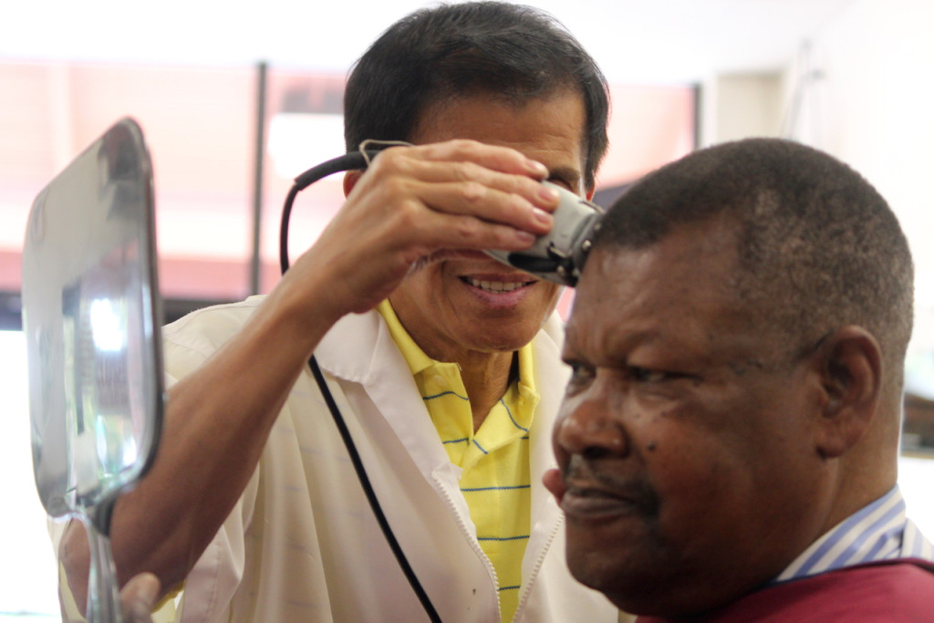 Castaneda uses a clipper to touch up a haircut for Celestino Gabriel, 76, a customer for more than 15 years. “Good people,” Gabriel said of those in the shop. “We’ve built up a friendship over the years.”