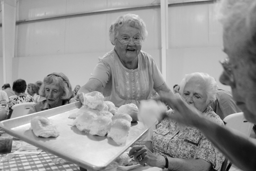 Marie Flinn of Pungo serves rolls to people gathered for the dinner at the Church of Christ at Creeds.