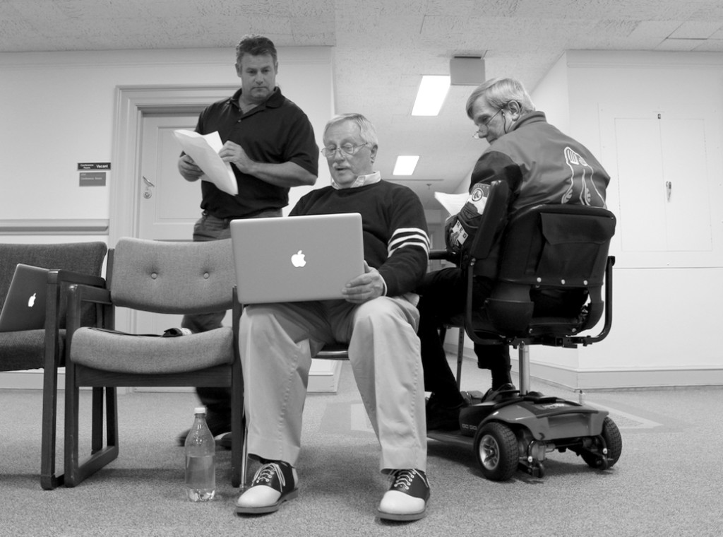 Chris Vandeberg of the Town Center area, Robert K. Dean of Waters Edge and Bill Johnson of Great Neck discussed potential costs for city support to the proposed arena on Tuesday, Dec. 1, at City Hall. The men compared notes during the city council meeting, sitting outside the chamber while the public hearing on the arena proposal continued. The three expressed opposition to the project. [John-Henry Doucette/The Princess Anne Independent News]