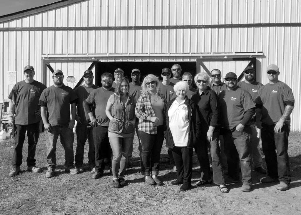 Volunteers from Dominion Power stand in front of the barn they began to paint with Lynn Bukowski and her family. [Courtesy photo/Bonita Billingsley Harris/Dominion Power]