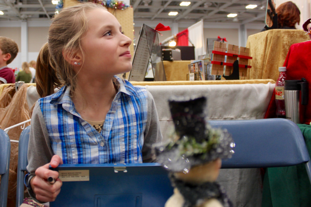 Eleven-year-old Lindsey Starke of Suffolk works with her grandmother’s crafting stand during the 34th Annual Virginia Beach Christmas Market at the Virginia Beach Convention Center, held Nov. 27-29. [John-Henry Doucette/The Princess Anne Independent News]