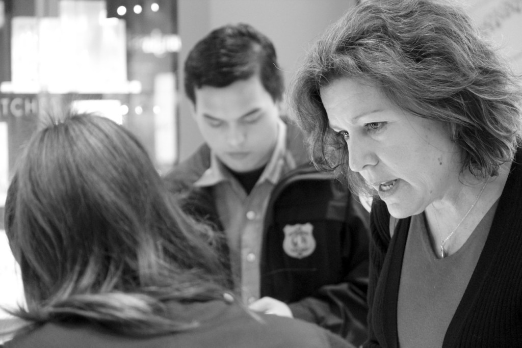 Master Police Officer Leta Krieger speaks with a merchant while Kevin Sarino, 17, takes notes. Sarino is a member of the Virginia Beach Explorers Post 911. [John-Henry Doucette/The Princess Anne Independent News]