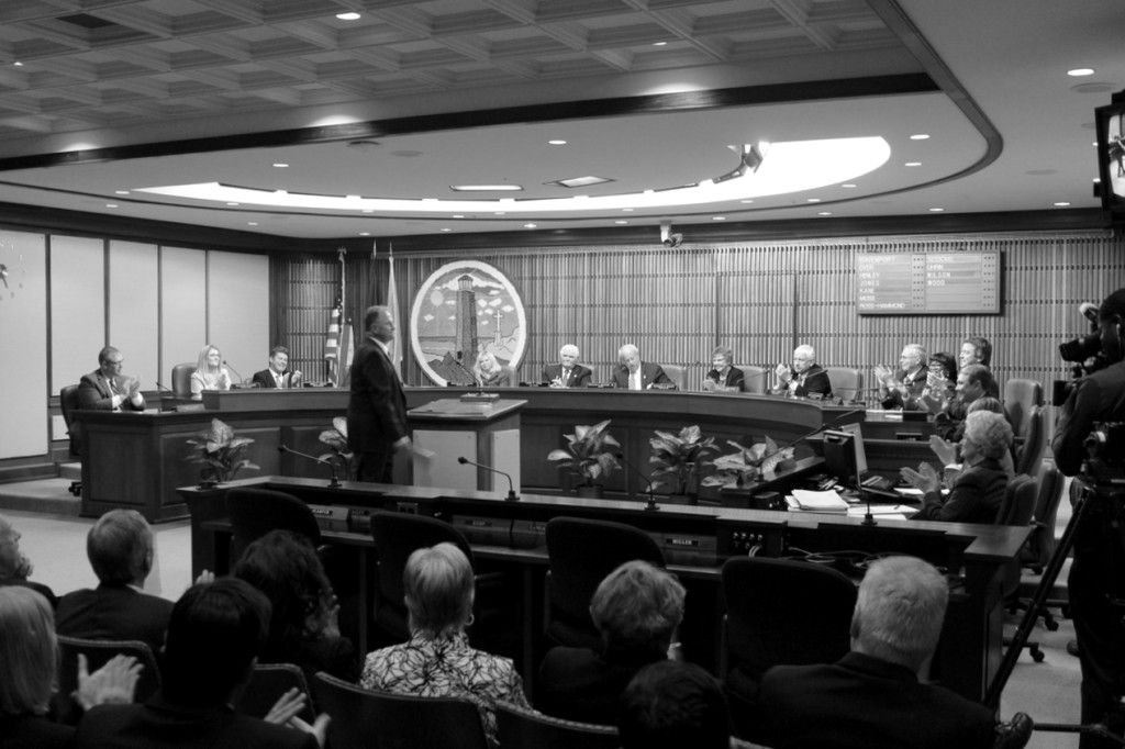Members of the city council and an audience that included a number of city department heads and employees applaud following the introduction of Dave Hansen as the new city manager for Virginia Beach. [John-Henry Doucette/The Princess Anne Independent News]