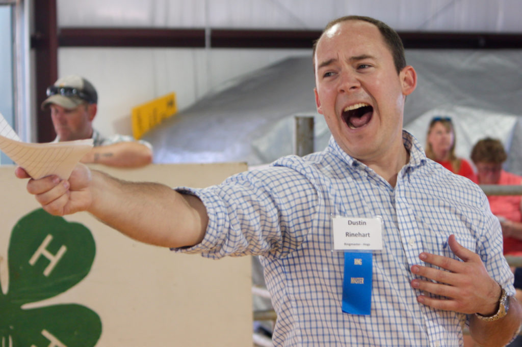 Dustin Rinehart calls in a bid to the auctioneer during the livestock auction, the culminating event. [John-Henry Doucette/The Princess Anne Independent News]