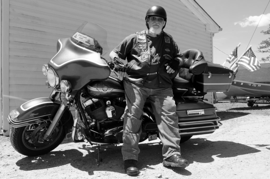 Paul “Bear” Angel is seen at West Neck Marina with his 2003 Electra Glide Classic Anniversary Edition, which he uses in rides to commemorate fallen members of the armed forces. [John-Henry Doucette/The Princess Anne Independent News]