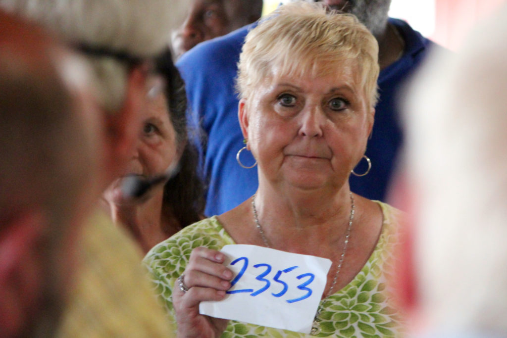 Sylvia Rose of Chesapeake, who said she comes to the auction every Wednesday, bids. [John-Henry Doucette/The Princess Anne Independent News]