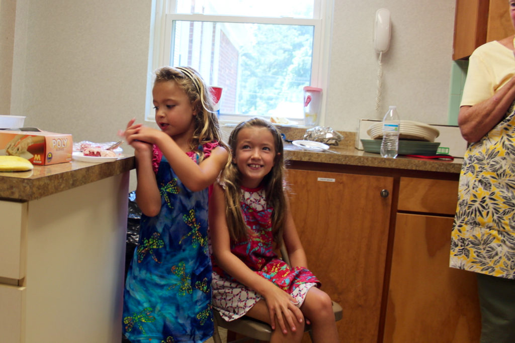 Sisters Hattie Peters, 6, and Henley Peters, 9, of Red Mill enjoyed cake in the kitchen during a break. [John-Henry Doucette/The Princess Anne Independent News]