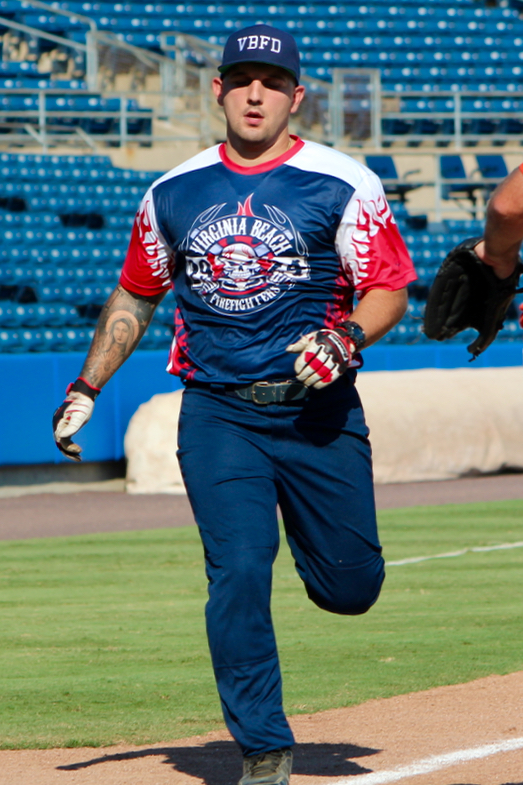  Firefighter Jose Aguerrebere, who is assigned to Station 19 at Stumpy Lake, scores a run during the charity softball game. [John-Henry Doucette/The Princess Anne Independent News]