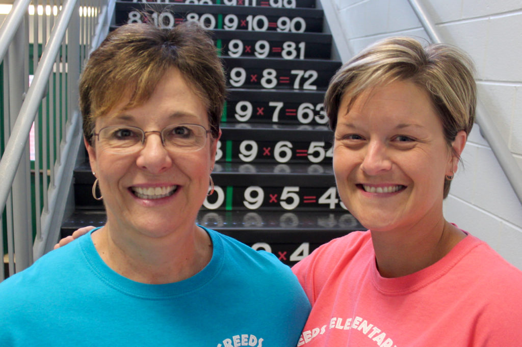 Creeds Elementary School office manager Debbie Brooks and principal Casey Conger created multiplication tables on stairs at the rural school over the summer. It’s a new learning opportunity for returning students. [John-Henry Doucette/The Princess Anne Independent News]