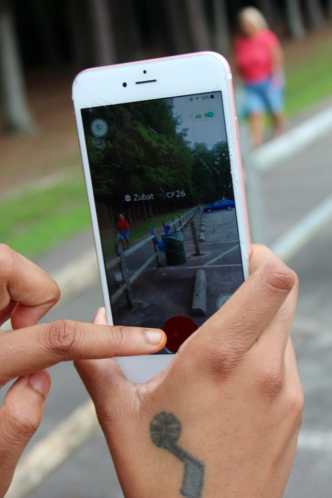 Jessica Scott, 24, a Navy corpsman, demonstrated Pokemon Go at Red Wing Park. [John-Henry Doucette/The Princess Anne Independent News]