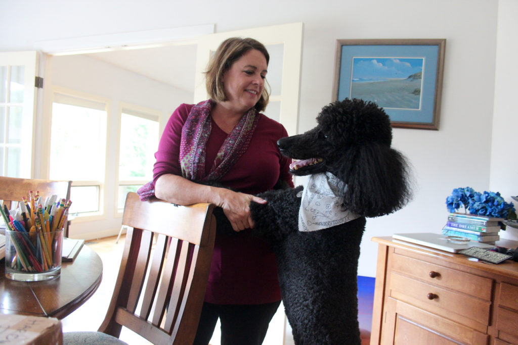 Photographer Sherry Friel, seen with Apollo, has an exhibition of her hyper-realistic, macro photography of flowers opening in October. [John-Henry Doucette/The Princess Anne Independent News]