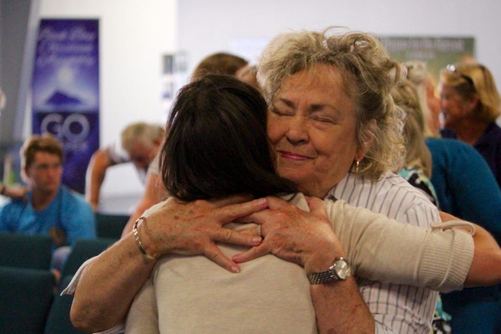Linda Etheridge of Back Bay shares a hug with Samantha Walker of Knotts Island, N.C., during a service on Sunday, Sept. 11. [John-Henry Doucette/The Princess Anne Independent News]