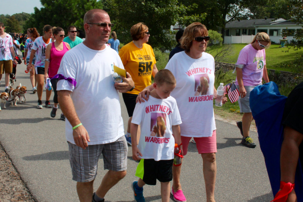 Keith and Robin Legg walk with their grandson, Kaedon Howley, in memory of Whitney Edwards. [John-Henry Doucette/The Princess Anne Independent News]