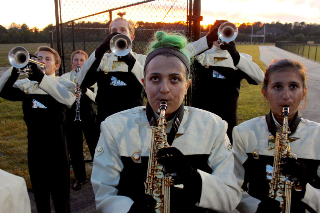 Ashlyn Campbell, 15, of Southgate and members of the band warm up before playing the National Anthem at the start of the Kellam-Salem game. [John-Henry Doucette/The Princess Anne Independent News]