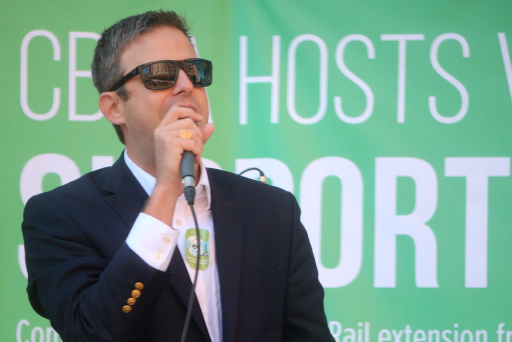 City Councilmember Ben Davenport addresses light rail extension supporters during a rally at Town Center on Saturday, Nov. 5. [John-Henry Doucette/The Princess Anne Independent News]